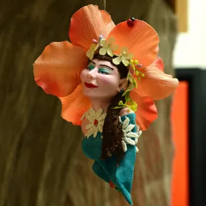 Orchid flower Ornament - Lovely female face with flowers in her hair surrounded by mini daisies